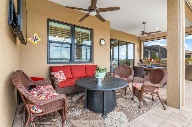 sunroom featuring ceiling fan