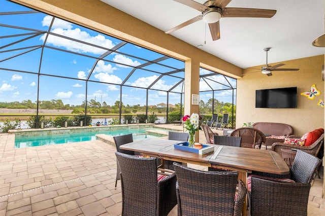 view of patio / terrace featuring ceiling fan, glass enclosure, and an outdoor hangout area