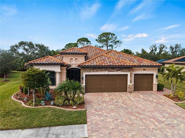 mediterranean / spanish-style house with a garage and a front lawn