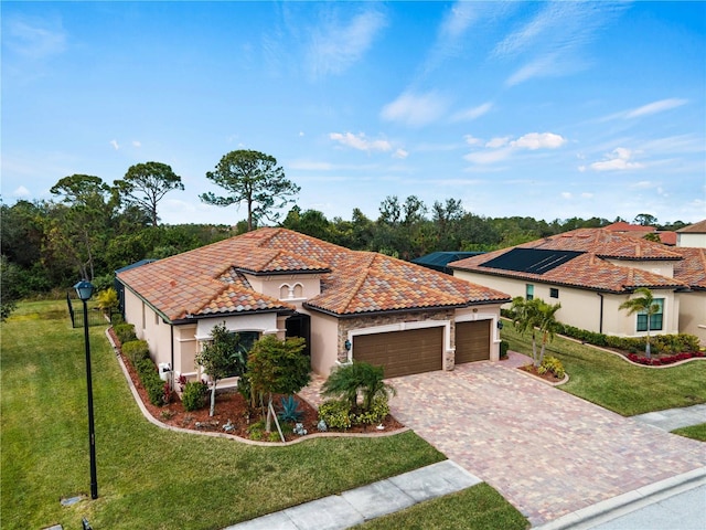 mediterranean / spanish-style house with a garage and a front yard