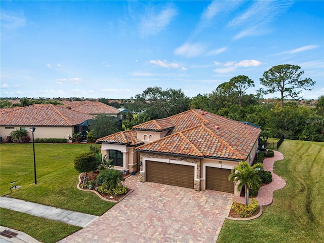 mediterranean / spanish house with a front yard and a garage