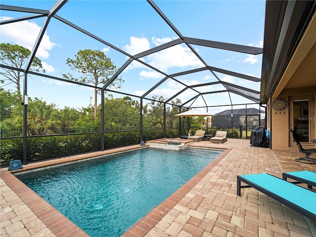 view of swimming pool with a lanai, a patio, and an in ground hot tub