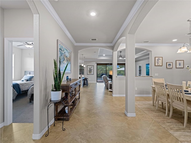 entryway featuring crown molding and ceiling fan with notable chandelier