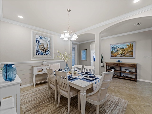 dining space with an inviting chandelier and ornamental molding