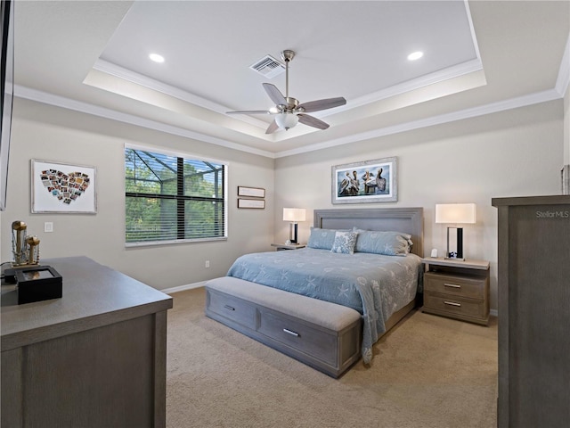 carpeted bedroom with a raised ceiling, ceiling fan, and ornamental molding