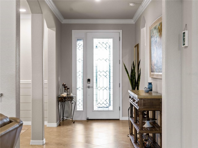 foyer with a wealth of natural light and crown molding