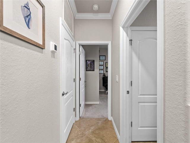 hallway with light colored carpet and ornamental molding