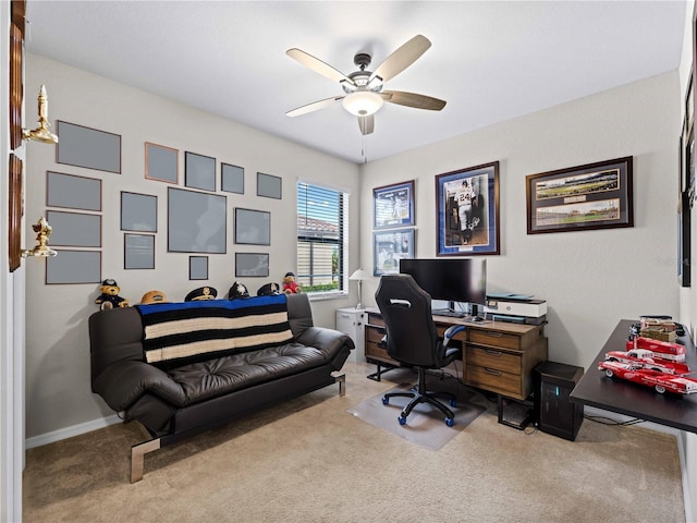 carpeted office space featuring ceiling fan