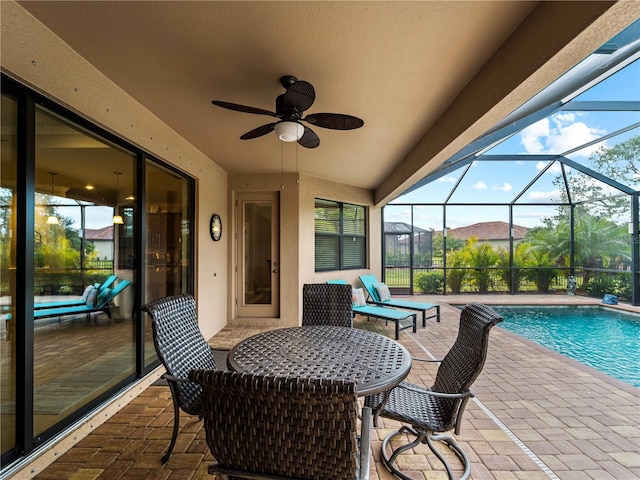 view of patio featuring a mountain view, a lanai, and ceiling fan