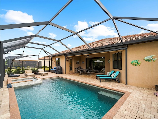 view of pool featuring a lanai, ceiling fan, and a patio area