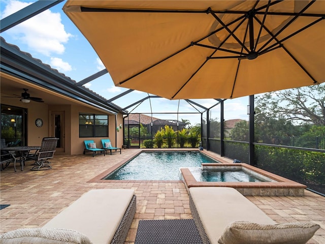 view of swimming pool with a lanai, ceiling fan, an in ground hot tub, and a patio