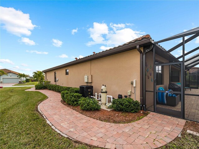 view of property exterior featuring a lanai and a yard