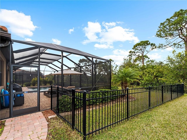 view of yard featuring a patio and glass enclosure