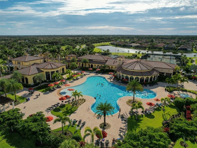 view of swimming pool featuring a water view and a patio