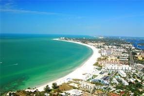 drone / aerial view with a water view and a beach view