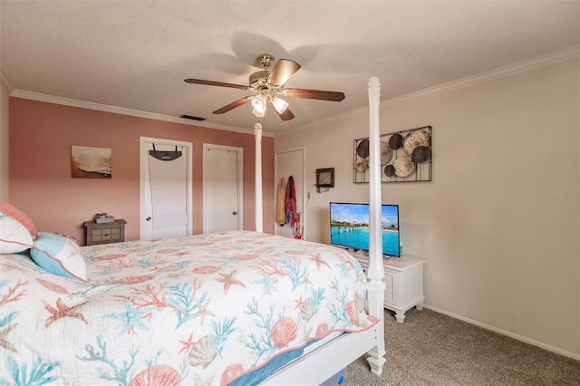 bedroom featuring ceiling fan, ornamental molding, carpet floors, and multiple closets