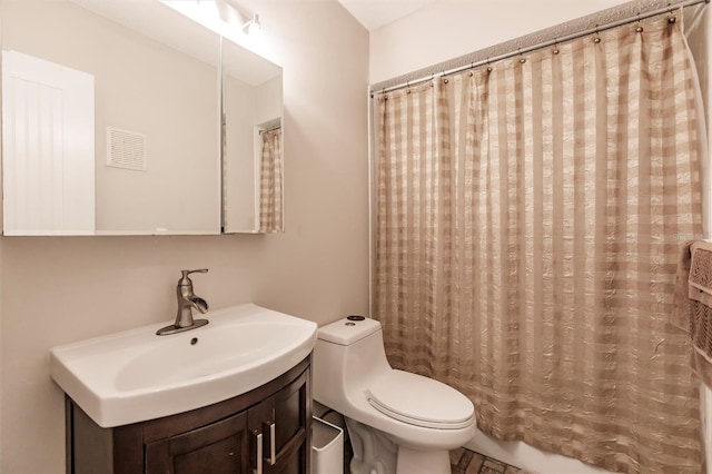 bathroom with toilet and vanity