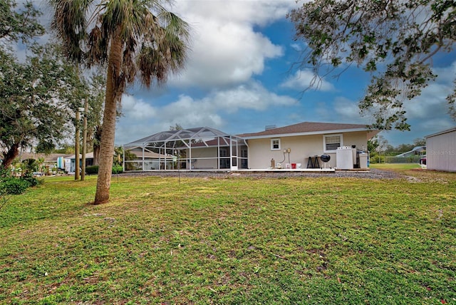 rear view of property featuring a yard