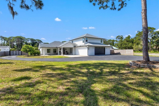 view of front of house with a garage and a front lawn