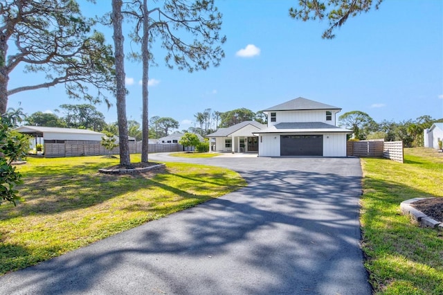 view of front of home with a garage and a front lawn