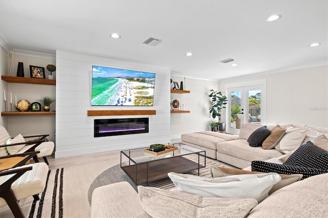 living room featuring light hardwood / wood-style flooring, a fireplace, ornamental molding, and french doors