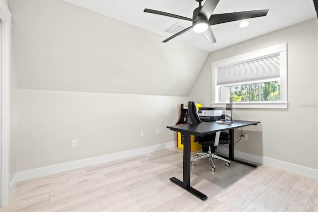 office space with vaulted ceiling, light wood-type flooring, and ceiling fan