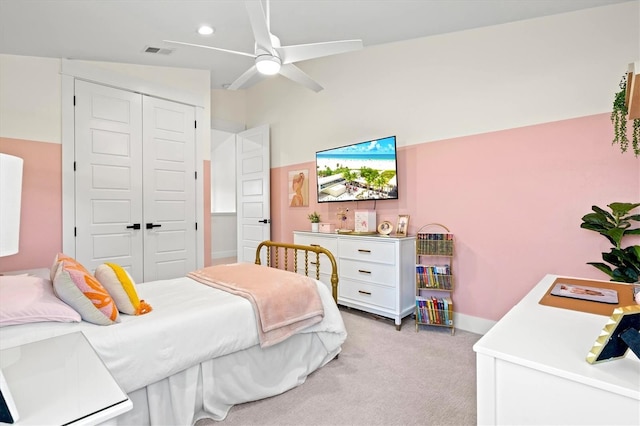 carpeted bedroom featuring ceiling fan and a closet