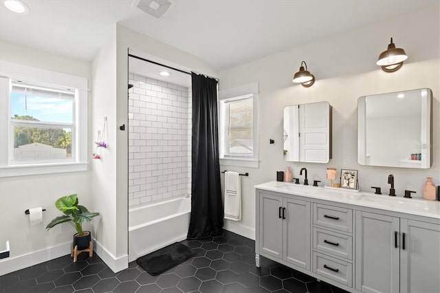 bathroom with shower / tub combo with curtain, vanity, and tile patterned flooring