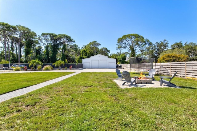 view of yard with an outdoor fire pit and a trampoline