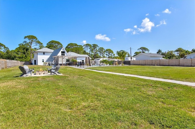 view of yard with a fire pit