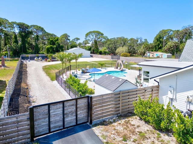 view of swimming pool with a patio area and a water slide