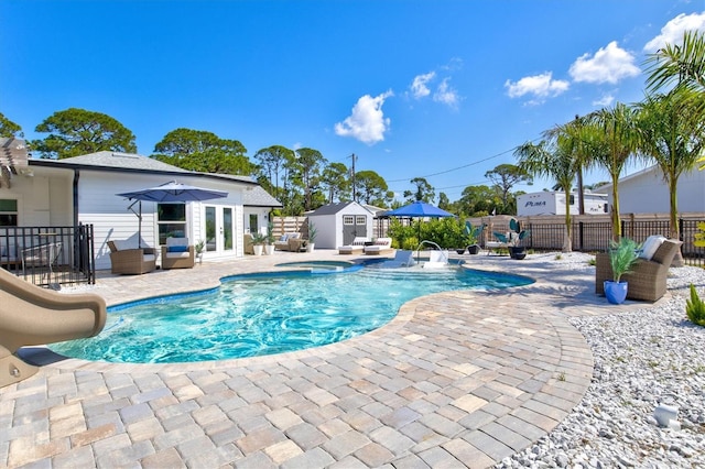 view of pool with an outdoor hangout area, a storage shed, a patio area, and a water slide