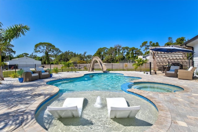 view of pool featuring a patio area, an in ground hot tub, pool water feature, and a water slide