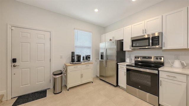 kitchen featuring stainless steel appliances and white cabinets