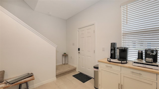 foyer entrance with light tile patterned flooring