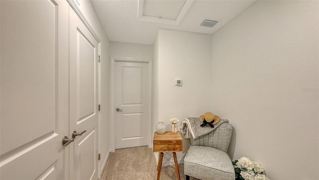 hallway featuring light colored carpet