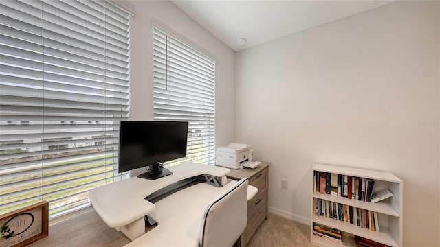 office area with light colored carpet and a healthy amount of sunlight