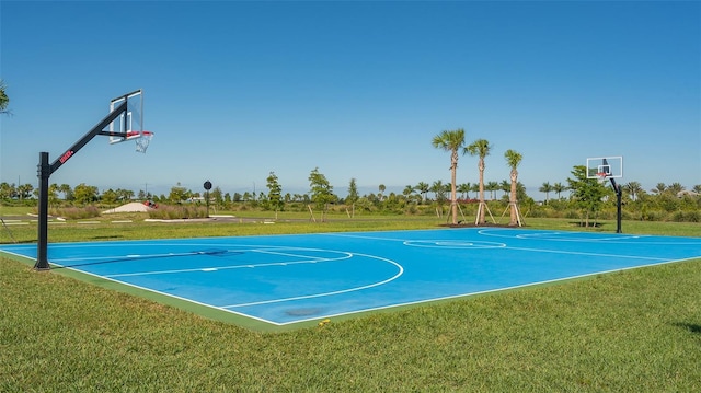 view of sport court featuring a lawn