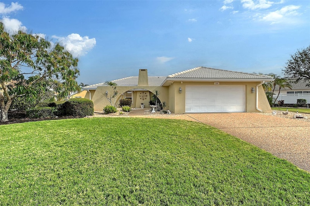 view of front of house with a garage and a front yard