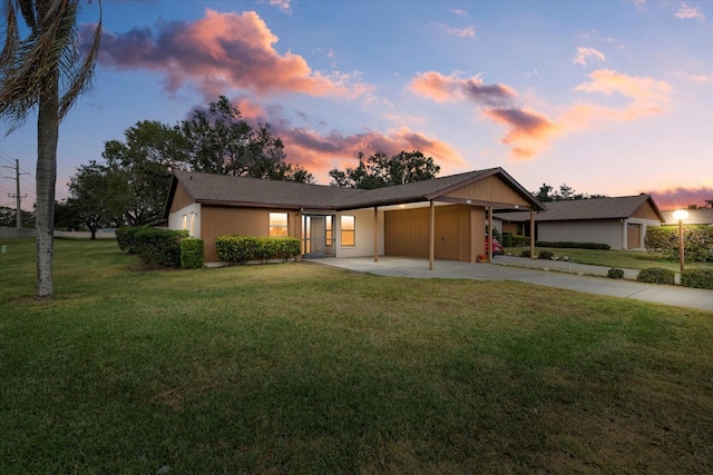 ranch-style house with a carport and a yard