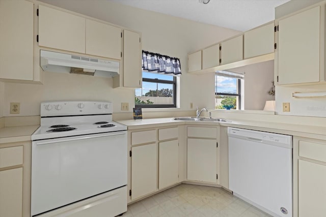 kitchen with sink, white appliances, and cream cabinets