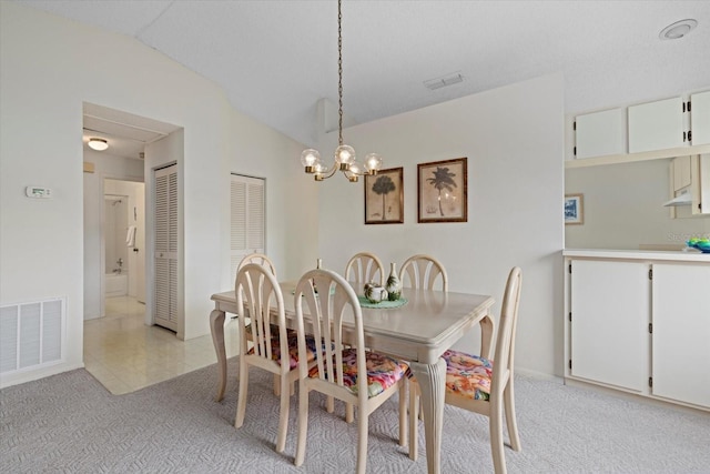 carpeted dining area featuring lofted ceiling and an inviting chandelier