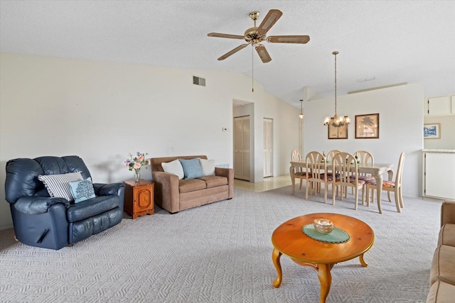 carpeted living room with ceiling fan with notable chandelier, a textured ceiling, and lofted ceiling