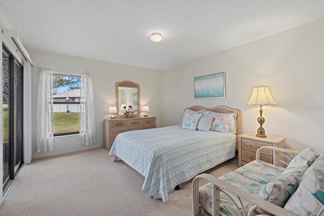 bedroom featuring light carpet and a textured ceiling