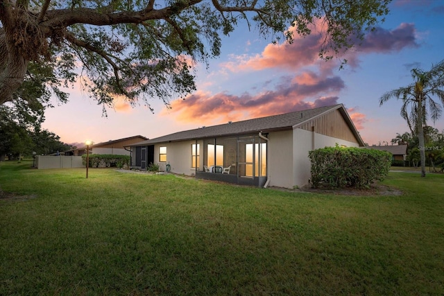 back house at dusk with a yard