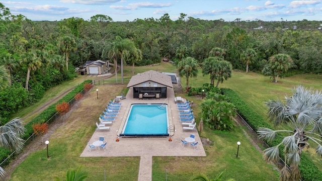 view of pool with an outdoor structure, a yard, and a patio