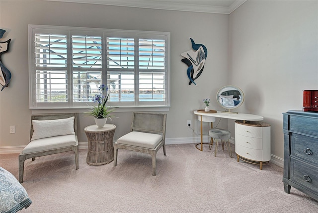 sitting room with ornamental molding and light colored carpet