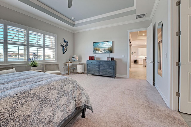 carpeted bedroom with ceiling fan, ornamental molding, and a tray ceiling