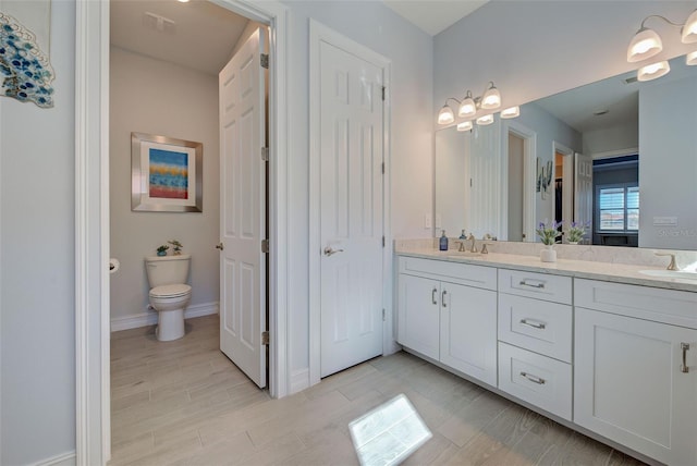 bathroom featuring vanity and toilet