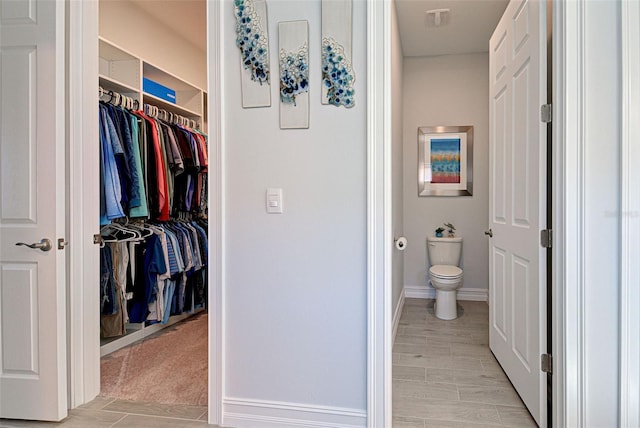 bathroom with hardwood / wood-style floors and toilet